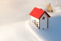 Protecting and isolating house. House model at snow background. Winter. Preparing the house for winter time. Real estate and