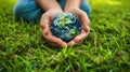 Protecting Our Planet: Hands Holding Earth on Green Grass Background for Environmental Concept Royalty Free Stock Photo