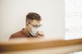 Asian man coughs and wears protective mask because of transmissible infectious diseases Royalty Free Stock Photo
