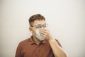Asian man coughs and wears protective mask because of transmissible infectious diseases Royalty Free Stock Photo