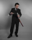 Protection, Aggressive businessman with Japanese swords in defensive and defensive pose Royalty Free Stock Photo