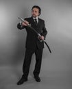 Protection, Aggressive businessman with Japanese swords in defensive and defensive pose Royalty Free Stock Photo
