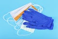 Protection concept - blue latex medical gloves and colored surgical mask on blue background Royalty Free Stock Photo