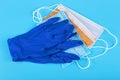 Protection concept - pair of blue latex medical gloves and colored surgical mask on blue background Royalty Free Stock Photo