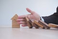 Protection finance from domino effect concept. Hands stop domino effect before destroy home Royalty Free Stock Photo