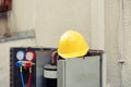 Protection helmet on air conditioner Royalty Free Stock Photo