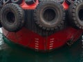 Protection of the sides of the ship in the form of old tires. Scale for submerging a ship in water. Tugboat in the port. The ship