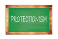 PROTECTIONISM text written on green school board