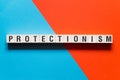 Protectionism word concept on cubes