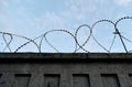 Protective barbed wire on the fence against the blue sky Royalty Free Stock Photo