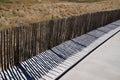 Protective barrier and its wooden summer shade from the dune to access the beach on Jard-sur-Mer in vendee france Royalty Free Stock Photo