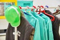 Protective clothes and green safety helmet on a coat rack Royalty Free Stock Photo