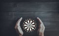 Protective Elderly Hands Holding Dartboard Representing Focus, Accuracy and Goal Protection Royalty Free Stock Photo