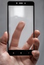 Protective glass for phone in male hand and finger touching the screen surface