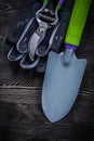 Protective gloves sharp secateurs shovel on wooden Royalty Free Stock Photo