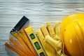 Protective gloves try square construction level wooden meter har Royalty Free Stock Photo