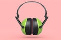 Protective green earphones muffs isolated on pink background