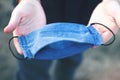 Protective handmade face mask in male hands, protection from coronavirus