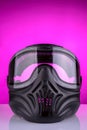 Protective head mask for playing paintball on a purple background Royalty Free Stock Photo