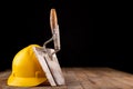 Protective helmet and tools for bricklayer. Work accessories for production workers