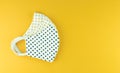 Protective mask for CoronavirusCOVID-19 and dust ,made of cotton black dot on yellow background,free space for your concept or