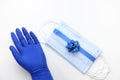 Protective masks tied with shiny blue ribbon with blue bow, Christmas decorations and blue glives Royalty Free Stock Photo