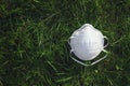 Protective medical mask on grass, epidemic of coronavirus covid-19. Coronavirus Epidemics, And The Risk Of Biological