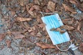 Protective medical mask is lying like garbage on the asphalt, the used mask was crushed and thrown away, medical waste, photos on