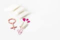 Protective menstrual pads, cotton tampons and gender symbol made from pink pain pills isolated on white. The concept of women