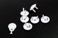 Protective Socket plugs on black  background  child safety  - Image Royalty Free Stock Photo