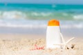 Protective sunscreen or sunblock and sunbath lotion in white plastic bottles on tropical beach, summer accessories in holiday, Royalty Free Stock Photo