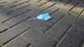 Protective surgical face mask thrown on the ground