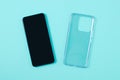 Protective transparent silicone case smartphone. Turquoise background Royalty Free Stock Photo