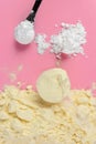 Protein powder caramel and white l-glutamine powder on pink background Royalty Free Stock Photo
