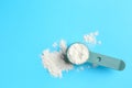 Protein powder and scoop on light blue background, top view. Space for text Royalty Free Stock Photo