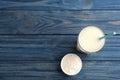 Protein shake and powder on blue wooden table. Space for text Royalty Free Stock Photo