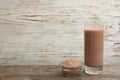 Protein shake and powder on table, space for text Royalty Free Stock Photo