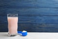 Protein shake and powder on white table, space for text Royalty Free Stock Photo