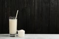 Protein shake and powder on white table, space for text Royalty Free Stock Photo