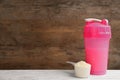 Protein shake and powder on white table, space for text Royalty Free Stock Photo