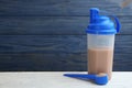 Protein shake and powder on table, space for text Royalty Free Stock Photo