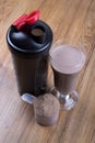 Protein shake, shaker and round scoop Royalty Free Stock Photo