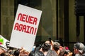 Protest against Immigration ICE and Border Patrol. A sign reads `Never Again`