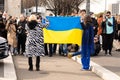 Milan, 24 Feb 2022. Protest against russian invasion into Ukraine. Two women hold ukranian flag as a patriotic symbol