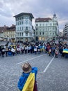 Protest against the war in Ukraine. Crowd of people in the square with flags and posters stop war stop putin slogans for