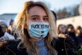 Protest against war in Ukraine and Russia`s invasion. Woman wearing mask with text