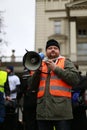 Man in orange vest with loudspeaker in the hand, The protest Committee the Defense of Democracy, Poznan, Poland Royalty Free Stock Photo