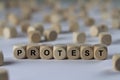 Protest - cube with letters, sign with wooden cubes