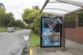 Protest Graffiti word `Bandidos` or in english Thiefs in a bus stop glass with a police car at background