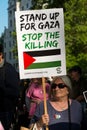 Protest messages on placards and posters at the Gaza: Stop The Massacre rally in Whitehall, London, UK.